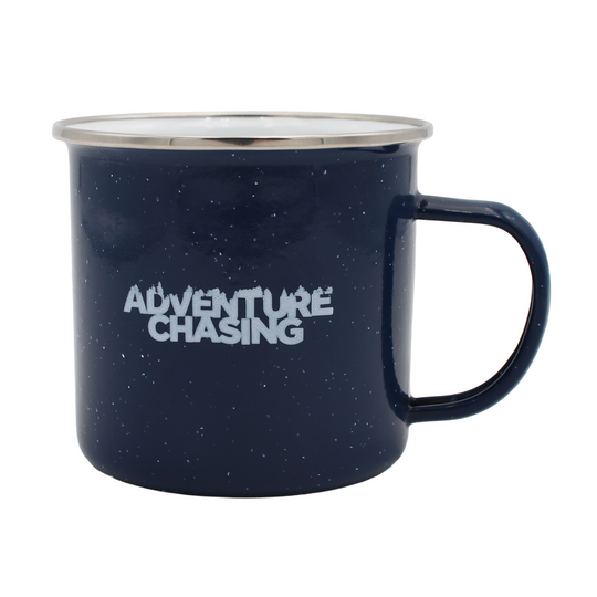 Navy blue speckled mug with white 'Adventure Chasing' text on the front and handle on the right.