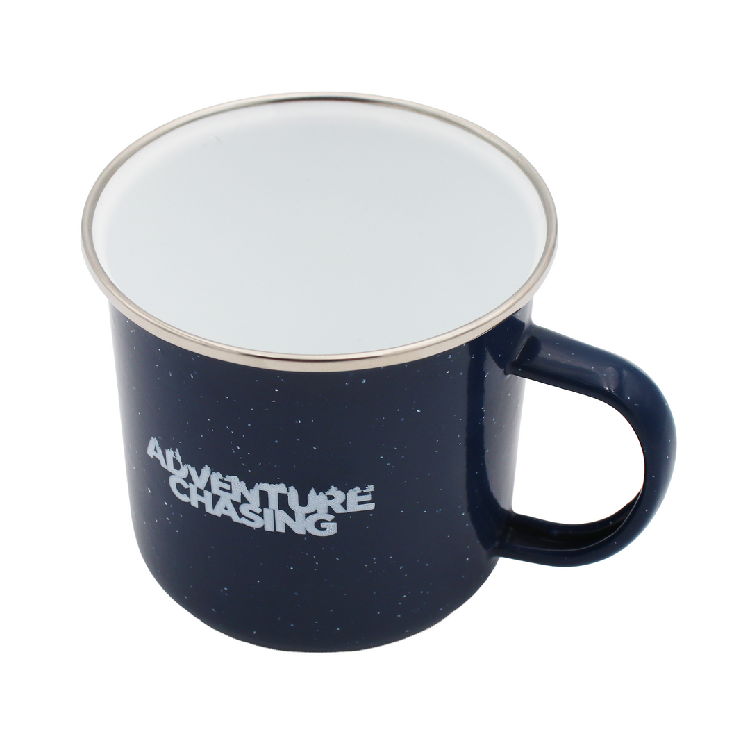 Inside of a blue speckled mug with a white interior and a handle on the right side.