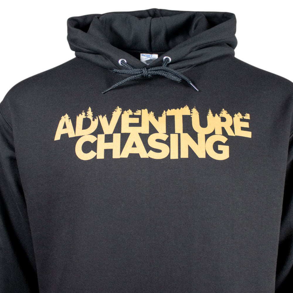 A black hoodie featuring the phrase 'ADVENTURE CHASING' in bold gold letters.