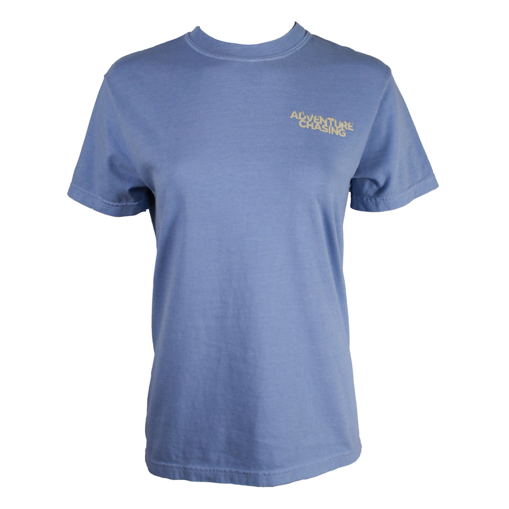 A light blue short-sleeve crewneck t-shirt with 'ADVENTURE CHASING' printed in beige on the left chest, displayed on a white background.