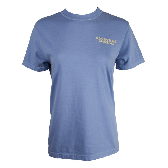 A light blue short-sleeve crewneck t-shirt with 'ADVENTURE CHASING' printed in beige on the left chest, displayed on a white background.