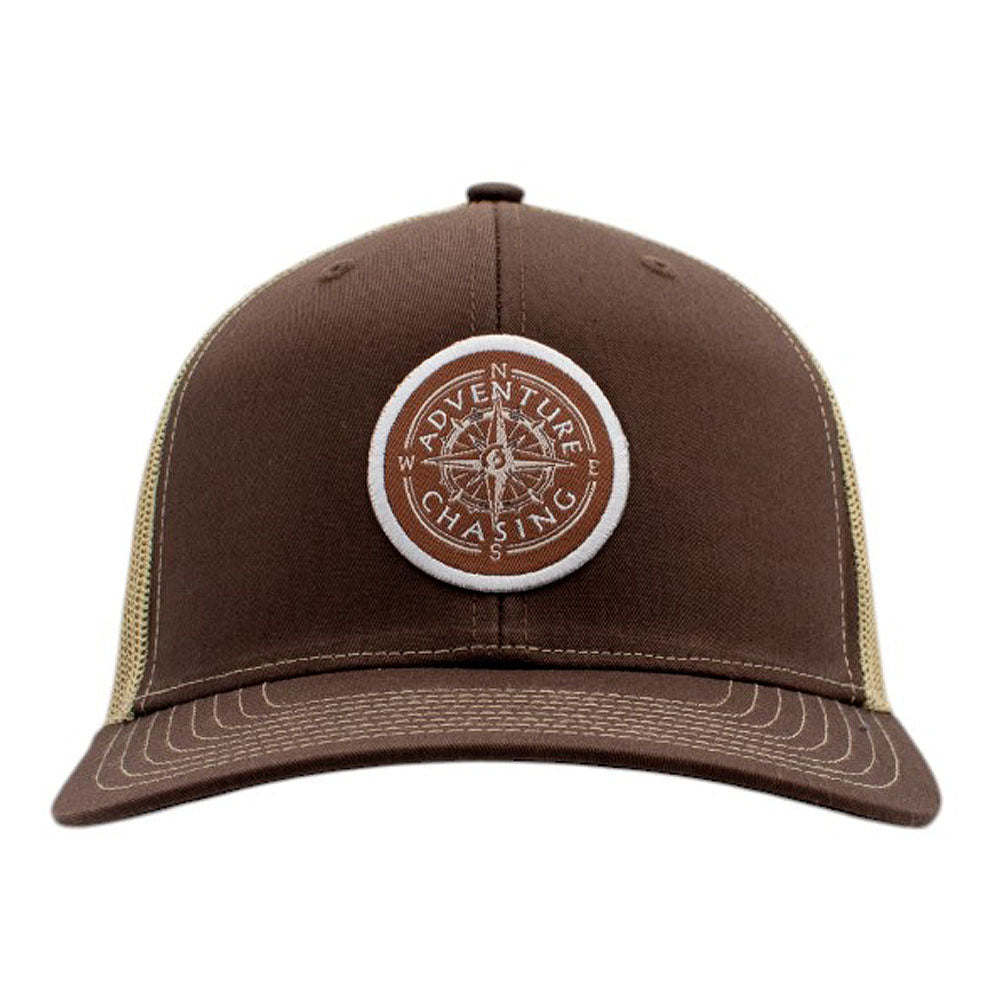 Brown cap with a circular 'Adventure Chasing' logo on the front.