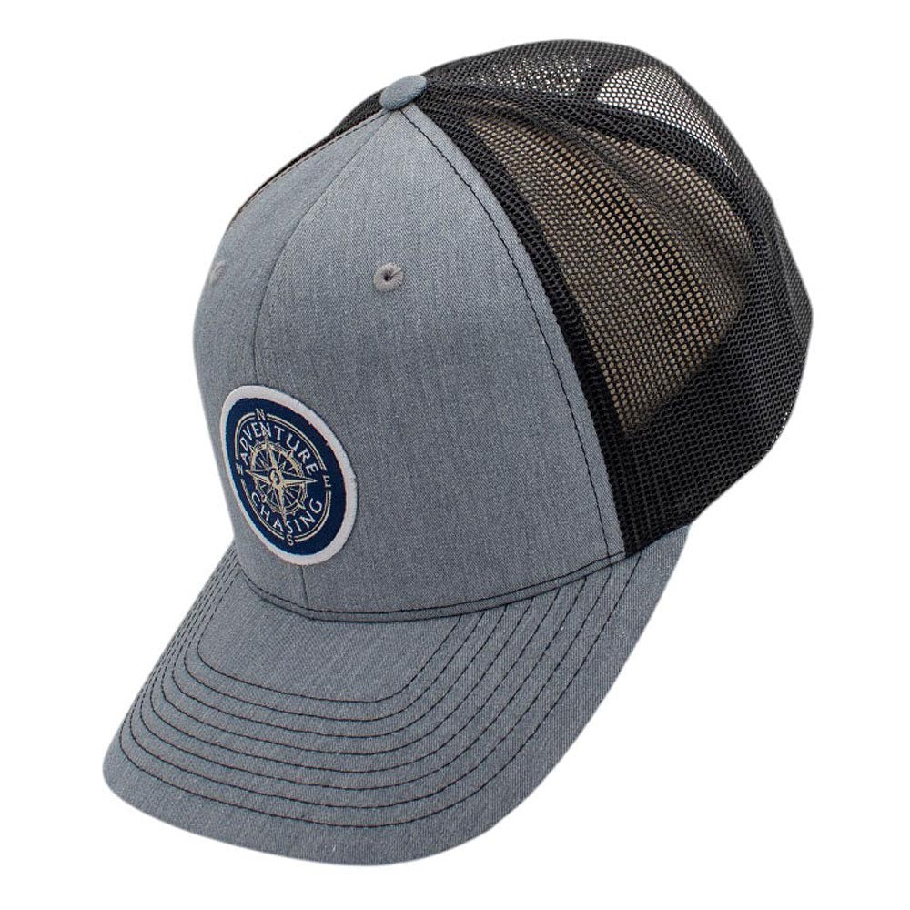 Gray and black trucker hat with a round logo on the front.