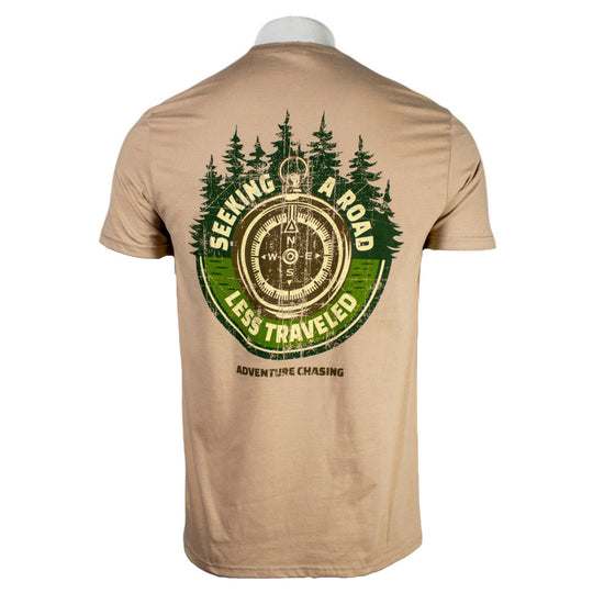 Beige t-shirt with a compass design and the text 'Seeking a road less traveled' surrounded by trees.